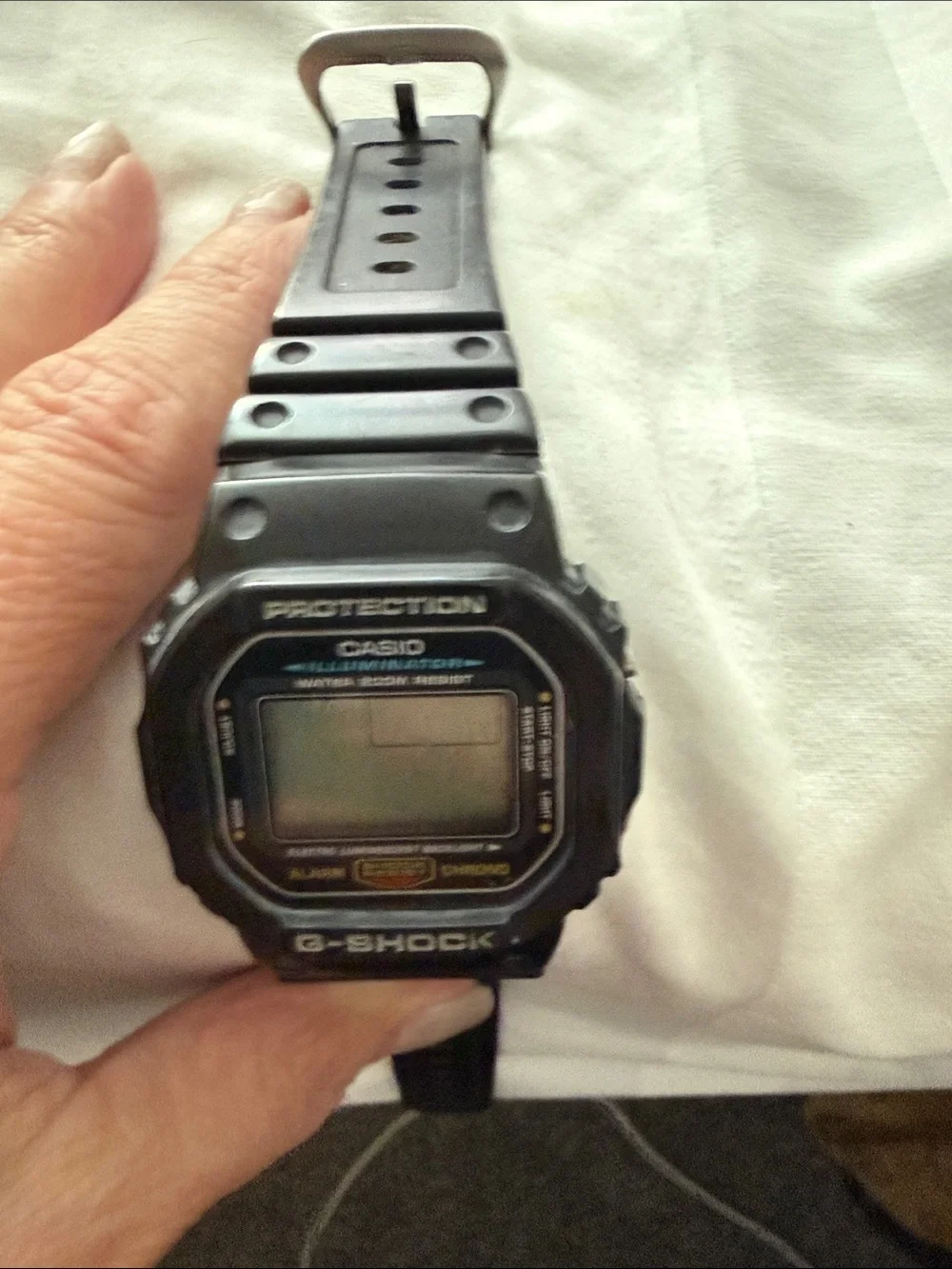 Black Casio illuminater digital watch. G-Shock resistant, waterproof.